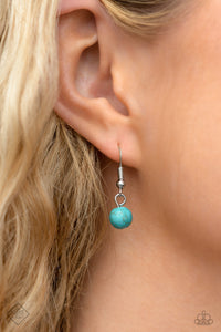 A collection of turquoise stones and white opalescent beads are featured in a range of pronged silver fittings and floral patterns, falling along the neckline in an artisanal display. The haphazard placement of each element further emphasizes their handcrafted charm, as the opalescent beads bring a hint of shimmer to the design. Features an adjustable clasp closure. As the stone elements in this piece are natural, some color variation is normal.
