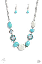 Load image into Gallery viewer, A collection of turquoise stones and white opalescent beads are featured in a range of pronged silver fittings and floral patterns, falling along the neckline in an artisanal display. The haphazard placement of each element further emphasizes their handcrafted charm, as the opalescent beads bring a hint of shimmer to the design. Features an adjustable clasp closure. As the stone elements in this piece are natural, some color variation is normal.
