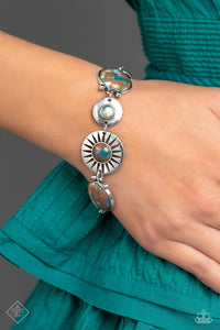 A collection of round and teardrop-shaped stones, marbled with swirls of brown, blue, and white, are pressed into silver frames before linking around the wrist. Textured silver discs round out the design, complementing the textures etched throughout the remaining frames. Features an adjustable clasp closure. As the stone elements in this piece are natural, some color variation is normal.  Sold as one individual bracelet.