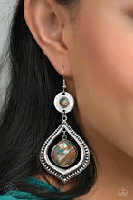 Load image into Gallery viewer, A brown stone marbled with blue and white is pressed into a thick circular silver frame. Dangling from the circular frame, an oversized silver spade-like frame etched in rural textures, features a larger brown stone marbled with blue and white, swinging from the top of the frame for an earthy lure. Earring attaches to a standard fishhook fitting. As the stone elements in this piece are natural, some color variation is normal.
