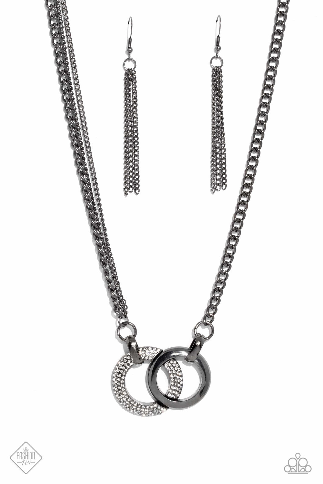 A pair of beveled gunmetal hoops interlock at the center of the collarbone, creating an eye-catching pendant. One hoop is coated in white rhinestones, while the other showcases a high-sheen finish, providing an intriguing collision of texture. The interlocking pendant is attached to a thick gunmetal chain, with a pair of daintier gunmetal chains added along one side for an asymmetrical finish. Features an adjustable clasp closure.  Sold as one individual necklace. Includes one pair of matching earrin