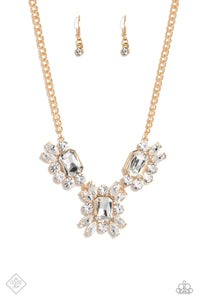 A dazzling collection of marquise- and round-cut white gems scatter around three oversized emerald-cut gems in the same radiant sheen. Pronged gold fittings elevate each gem, maximizing their sparkle as they fall into an asymmetrical statement piece, anchored by a thick gold chain. Features an adjustable clasp closure.