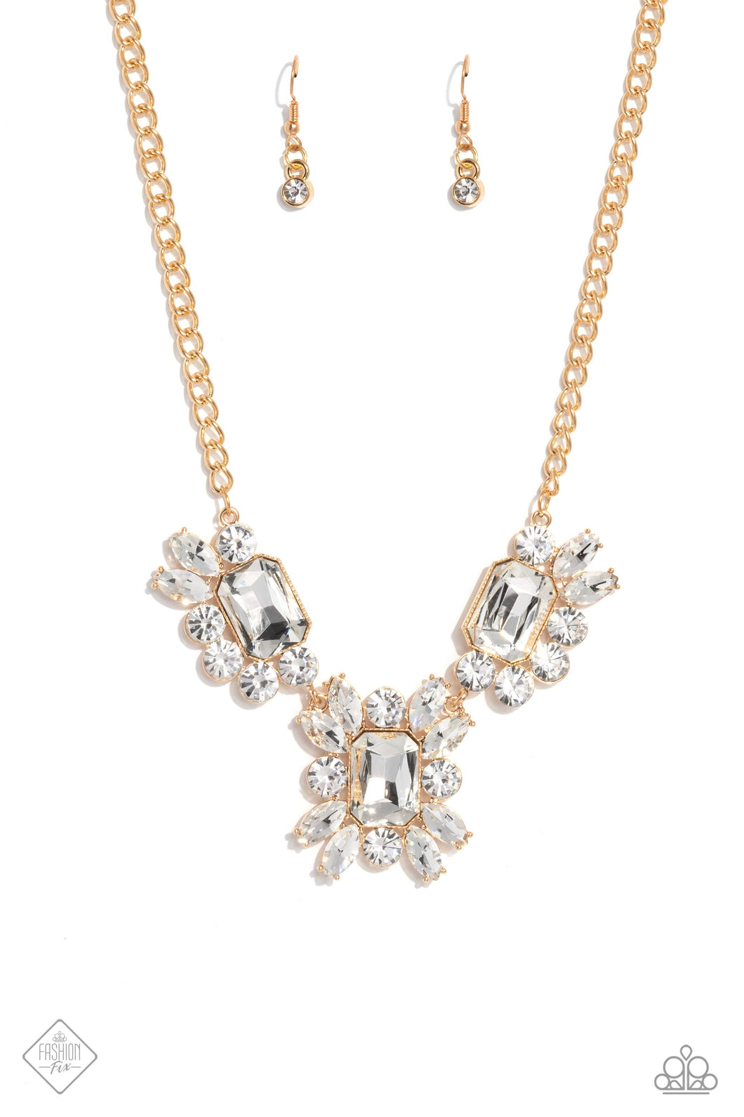 A dazzling collection of marquise- and round-cut white gems scatter around three oversized emerald-cut gems in the same radiant sheen. Pronged gold fittings elevate each gem, maximizing their sparkle as they fall into an asymmetrical statement piece, anchored by a thick gold chain. Features an adjustable clasp closure.