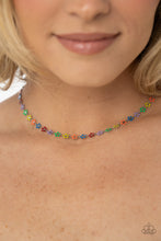 Load image into Gallery viewer, Dotted with dainty silver flower centers, colorful petaled flowers link below the collar for a colorfully seasonal look. Features an adjustable clasp closure.
