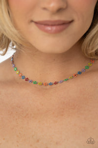 Dotted with dainty silver flower centers, colorful petaled flowers link below the collar for a colorfully seasonal look. Features an adjustable clasp closure.