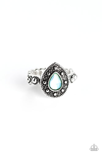 An opalescent blue teardrop is encased in an ornate frame of studded and rope-like textures, creating a grand display atop the finger. Dainty textured studs grace the silver band for additional eye-catching detail. Features a dainty stretchy band for a flexible fit. 