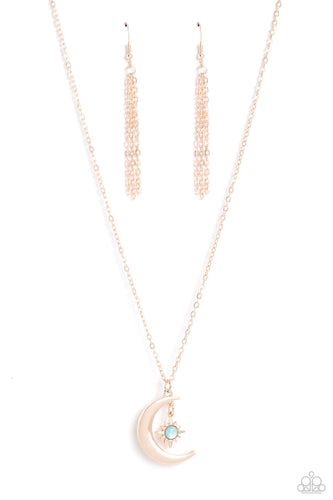 A glassy blue bead is pressed into the center of a three-dimensional rose gold star that dances from the top of a rose gold crescent moon pendant, creating a celestial pendant at the bottom of a dainty rose gold chain. Features an adjustable clasp closure. 