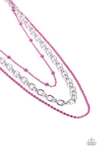 A sleek silver link chain swings from the middle of a display of mismatched dainty pink chains, creating an edgy layered display. Features an adjustable clasp closure. 