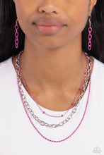 Load image into Gallery viewer, A sleek silver link chain swings from the middle of a display of mismatched dainty pink chains, creating an edgy layered display. Features an adjustable clasp closure. 
