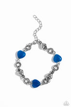 Load image into Gallery viewer, Heart-shaped lapis and sleek silver hearts alternate along the wrist. Bubbly textured silver rings separate each heart shape infusing the romantically earthy design with a touch of high-sheen detail. Features an adjustable clasp closure. As the stone elements in this piece are natural, some color variation is normal.

