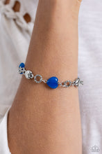 Load image into Gallery viewer, Heart-shaped lapis and sleek silver hearts alternate along the wrist. Bubbly textured silver rings separate each heart shape infusing the romantically earthy design with a touch of high-sheen detail. Features an adjustable clasp closure. As the stone elements in this piece are natural, some color variation is normal.
