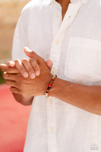 Infused along a stretchy band around the wrist, a strand of colorful glassy, stone, and acrylic beads joins a spotted collection of wood beads for a colorfully urban look. As the stone elements in this piece are natural, some color variation is normal. 