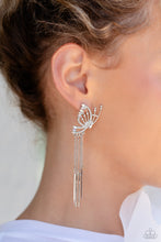 Load image into Gallery viewer, Featuring dainty white rhinestones and dainty marquise-cut iridescent gems, a thin, elongated, airy silver butterfly is titled to the side as if about to take off in flight. A collection of dainty silver rods swings from dainty silver chain tassels at the bottom of the whimsical frame for some free-falling movement. Earring attaches to a standard post fitting. Due to its prismatic palette, color may vary. 
