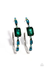 Load image into Gallery viewer, Encrusted in round and emerald-cut aquamarine and emerald gems, some featuring an iridescent sheen, an exaggerated oblong silver hoop curls around the ear, refracting light in a dramatic, knockout finish. Earring attaches to a standard post fitting. Hoop measures approximately 2&quot; long. Due to its prismatic palette, color may vary.
