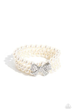 Load image into Gallery viewer, Strung along elastic stretchy bands, three strands of high-sheen classic white pearls wrap around the wrist. Featured atop the pearly collection, a loopy silver bow, filled with glistening white rhinestones is attached to the center of the wrist for a dramatically dazzling finish.

