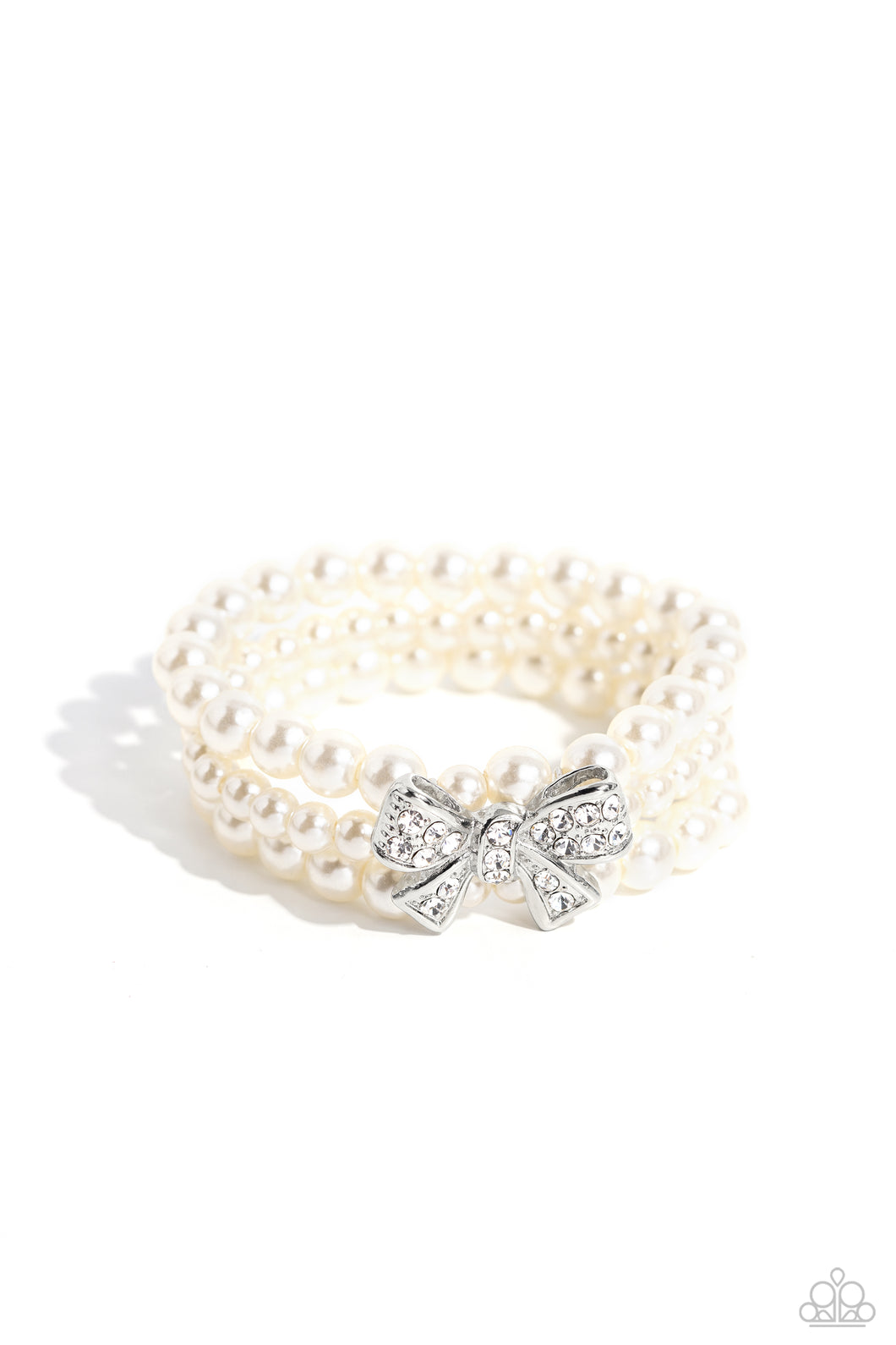 Strung along elastic stretchy bands, three strands of high-sheen classic white pearls wrap around the wrist. Featured atop the pearly collection, a loopy silver bow, filled with glistening white rhinestones is attached to the center of the wrist for a dramatically dazzling finish.