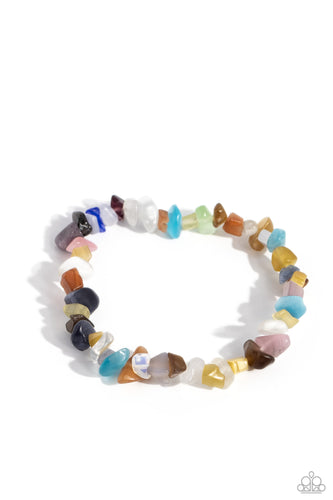 An earthy collection of multicolored chiseled pebbles are threaded along a stretchy band around the wrist in a free-spirited pattern. 