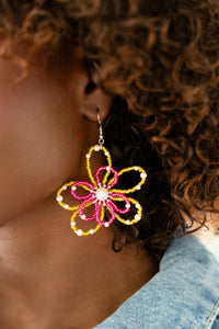 A glossy white pearl blooms from the center of a layered Pink Peacock and High Visibility glassy seed bead flower, infused with additional dainty white pearls, creating a colorful floral frame. Earring attaches to a standard fishhook fitting.