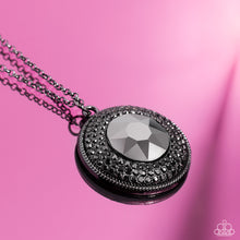 Load image into Gallery viewer, Sparkling with an oversized hematite center, a concaved gunmetal disc encompassing radiating rows of shimmering hematite rhinestones cascades from an elongated gunmetal chain, creating a striking impact. Features an adjustable clasp closure. 
