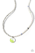 Load image into Gallery viewer, A strand of oval white pearls, sporadically infused with multicolored-striped beads, collides with cubed silver beads and studs to create an abstract blend of elegance and sheen. A yin-yang charm featuring white and Kohlrabi accents and star and lightning bolt symbols dangles from the bottom of the contrasting design for the perfect balance of color. Features an adjustable clasp closure. 
