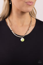 Load image into Gallery viewer, A strand of oval white pearls, sporadically infused with multicolored-striped beads, collides with cubed silver beads and studs to create an abstract blend of elegance and sheen. A yin-yang charm featuring white and Kohlrabi accents and star and lightning bolt symbols dangles from the bottom of the contrasting design for the perfect balance of color. Features an adjustable clasp closure. 
