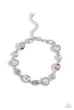 Load image into Gallery viewer, Featuring pronged silver fittings, white solitaire rhinestones alternate with oval opalescent and iridescent gems, linking around the wrist for a timeless, dreamy finish. Features an adjustable clasp closure. Due to its prismatic palette, color may vary. 
