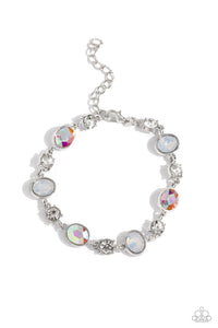 Featuring pronged silver fittings, white solitaire rhinestones alternate with oval opalescent and iridescent gems, linking around the wrist for a timeless, dreamy finish. Features an adjustable clasp closure. Due to its prismatic palette, color may vary. 