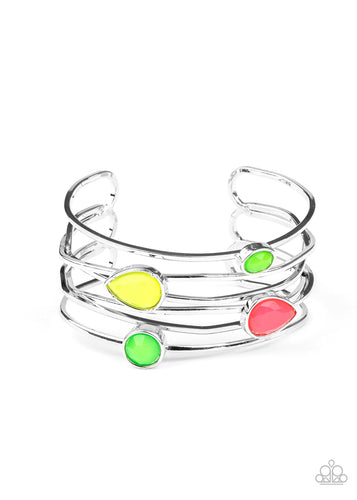 Varying in shape, a neon collection of faceted green, pink, and Green Sheen beads haphazardly dot the tops of imperfect crisscrossing silver bars, coalescing into a colorfully retro cuff around the wrist. Sold as one individual bracelet.