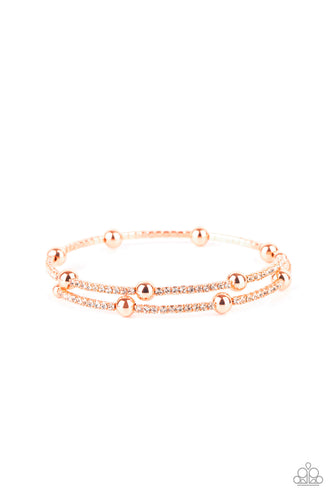 Dainty sections of glassy white rhinestones and shiny copper beads delicately coil around the wrist, creating a timeless shimmer.