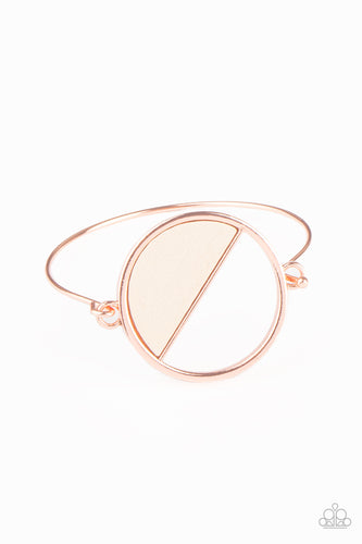 Attached to a dainty shiny copper bar that curls around the wrist, a crescent shaped white wooden accent adorns half of an airy circular centerpiece for a modern twist. Features a toggle closure.  Sold as one individual bracelet.