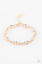 Load image into Gallery viewer, Varying in size, pairs of glassy white rhinestones are encrusted along glistening gold frames and linked around the wrist for a timeless finish. Features an adjustable clasp closure.
