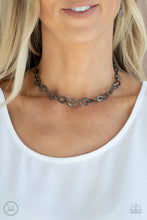 Load image into Gallery viewer, Embossed in a metallic crocodile-like print, asymmetrical gunmetal links delicately connect around the neck for a wild industrial inspired look. Features an adjustable clasp closure.
