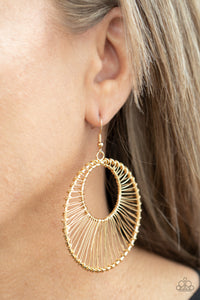 Glistening gold wire wraps around two gold hoops, creating an airy crescent shaped frame for an artisan inspired fashion. Earring attaches to a standard fishhook fitting.  Sold as one pair of earrings.