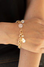 Load image into Gallery viewer, White crystal-like beads, a dainty white rhinestone, and a gold disc stamped in the word, &quot;love,&quot; adorn a double-linked gold chain, creating a flirty fringe around the wrist. Features an adjustable clasp closure.  Sold as one individual bracelet.
