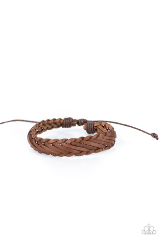 Rustic leather laces decoratively weave around the wrist, creating a rugged centerpiece. Features an adjustable sliding knot closure.
