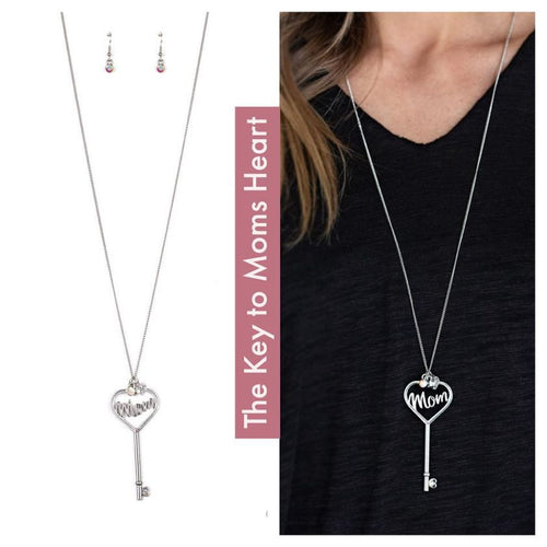 Dotted with dainty iridescent rhinestones, glistening silver filigree spells the word, 