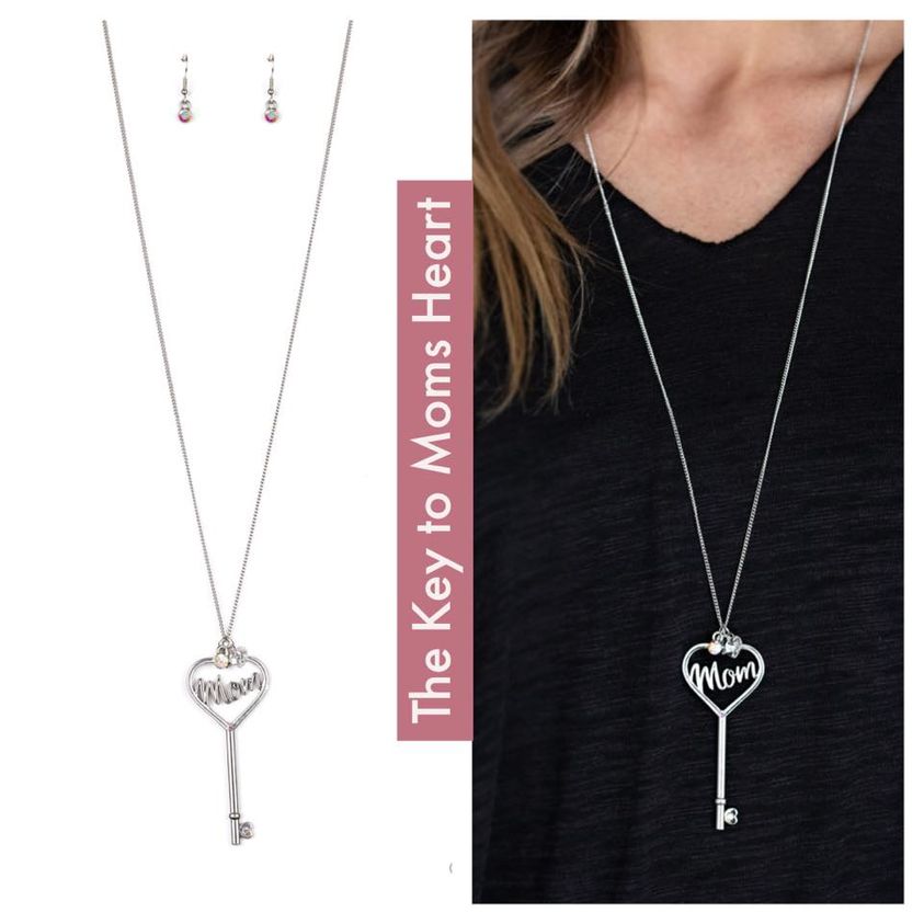 Dotted with dainty iridescent rhinestones, glistening silver filigree spells the word, 