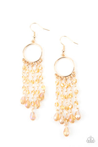 Glittery rows of iridescently golden crystal-like beads stream from the bottom of a dainty gold hoop, creating a dazzling chandelier. Earring attaches to a standard fishhook fitting.