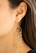 Load image into Gallery viewer, Glittery rows of iridescently golden crystal-like beads stream from the bottom of a dainty gold hoop, creating a dazzling chandelier. Earring attaches to a standard fishhook fitting.
