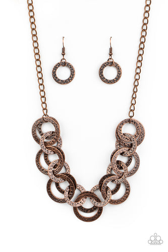 Brushed in an antiqued shimmer, delicately hammered copper discs connect below the collar for a bold industrial look. Features an adjustable clasp closure.