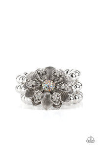 A daring oversized silver flower is composed of petals lined in antiqued silver and dotted with glistening dainty white rhinestones. Life of the Party Exclusive January 2022