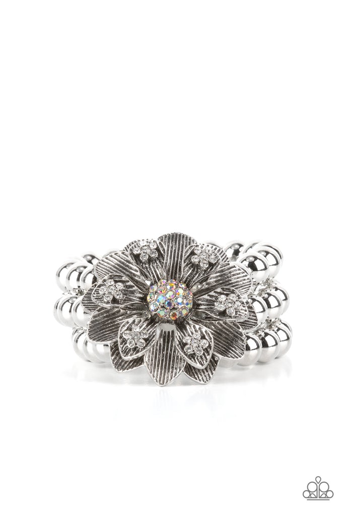 A daring oversized silver flower is composed of petals lined in antiqued silver and dotted with glistening dainty white rhinestones. Life of the Party Exclusive January 2022
