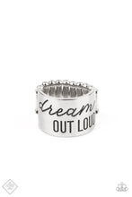 Load image into Gallery viewer, The front of a thick silver band is stamped in the phrase, &quot;Dream out loud,&quot; creating an inspirational centerpiece across the finger. Features a stretchy band for a flexible fit.  Sold as one individual ring.
