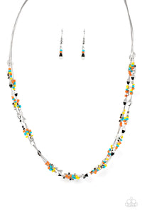 A dainty collection of faceted silver beads, multi-colored seed beads, and silver cubes are threaded along multiple strands of silver wire below the collar, creating clustered layers. Features an adjustable clasp closure.  Sold as one individual necklace. Includes one pair of matching earrings.   Get The Complete Look! Bracelet: Elite Explorer - Multi (Sold Separately)