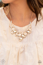 Load image into Gallery viewer, A bubbly collection of champagne cat&#39;s eye stones, glassy white rhinestones, and glistening gold discs delicately coalesces into enchanting frames below the collar that link into a whimsical centerpiece. Features an adjustable clasp closure.  Sold as one individual necklace. Includes one pair of matching earrings.  New Kit Fashion Fix
