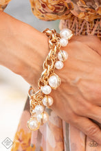 Load image into Gallery viewer, Classic white pearls and solitaire pearls that are threaded along a rod inside imperfect gold rings swing from a chunky double-linked gold chain around the wrist, creating a dramatic fringe. Features an adjustable clasp closure.  Sold as one individual bracelet.
