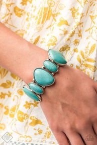 Featuring imperfect shapes, refreshing turquoise stones are pressed into asymmetrical silver frames that are threaded along stretchy bands that wrap around the wrist for an earthy look.