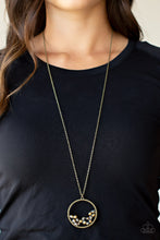 Load image into Gallery viewer, A cluster of metallic flecked aurum and iridescent crystal-like beads are threaded along dainty brass wire along the bottom of a textured brass hoop, creating a stellar pendant at the bottom of a lengthened brass chain. Features an adjustable clasp closure.  Sold as one individual necklace. Includes one pair of matching earrings.
