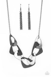 Large triangular cutouts stamped in a lightly dotted texture link below the collar forming a dramatic display of gunmetal slices. Features an adjustable clasp closure.  Sold as one individual necklace. Includes one pair of matching earrings.