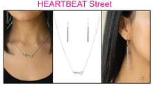 Load image into Gallery viewer, Reminiscent of a heartbeat, a wavy silver bar attaches to a charming heart silhouette for a simply beautiful display. Dazzling white rhinestones are sprinkled along the heart charm for a sparkling finish. Features an adjustable clasp closure.  Sold as one individual necklace. Include one pair of matching earrings.
